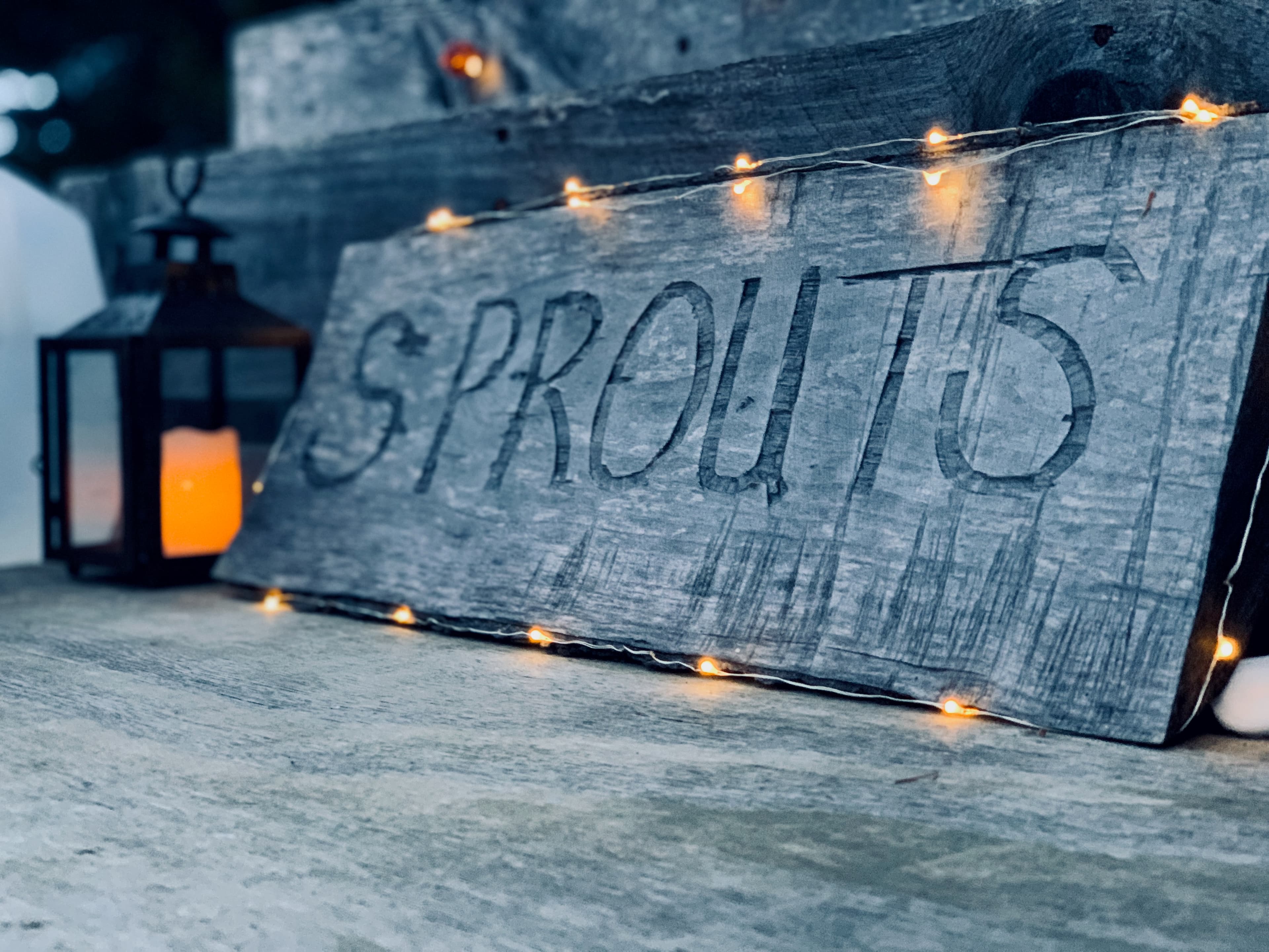 Rustic wooden Sprouts sign with fairy lights